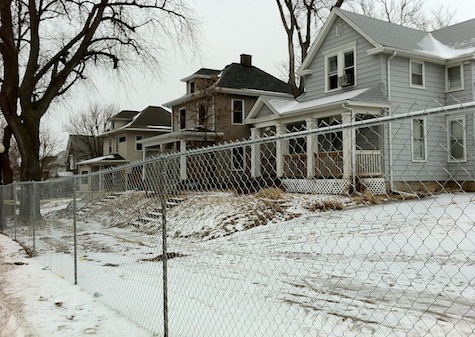 Vintage Dundee homes behind newly erected chain-link fence. All will be demolished, along with the building that housed The 49'r, to make way for a CVS Pharmacy
